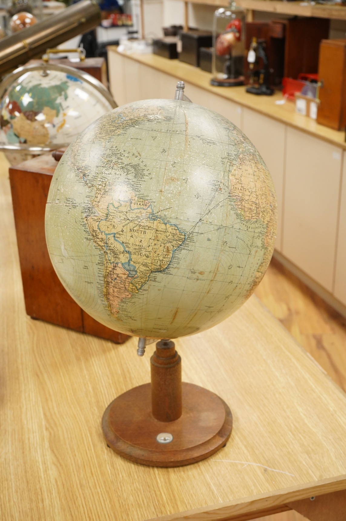A mid 20th century 12 inch terrestrial globe on an oak base with integrated compass, the globe printed with; ‘Printed in Germany’, overall height 55cm